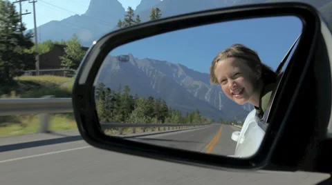 Girls reflection in a rearview mirror, moving car. Видео 8664722