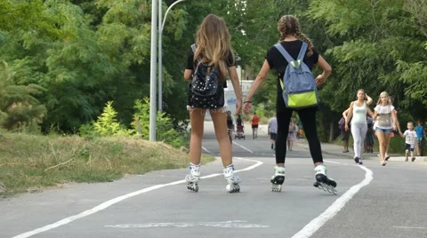Girls ride on rollers Stock Footage 65612295