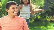 Girls Run Up Behind Their Dad And Jump On His Back Stock Footage