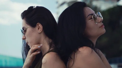 Girls sit back to back Stock Footage 113056530