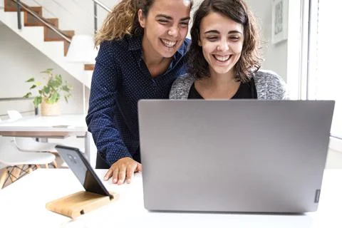 Girls smiling looking at the computer Stock Photos