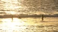 Girls Surfing in Ocean at Sunset 4k or 4k+ Resolution