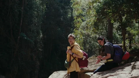 Girls Taking a Break While Hiking on Rocky Terrain Stock Footage 237288953