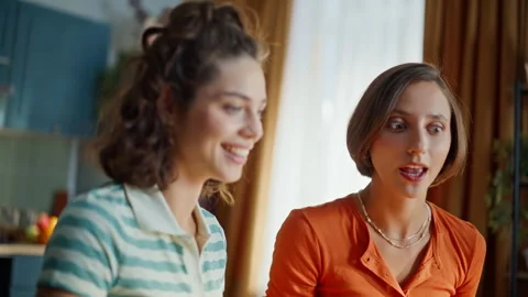 Girls talking web chat sitting home kitchen closeup. Smiling women video calling Stock Footage 333793229