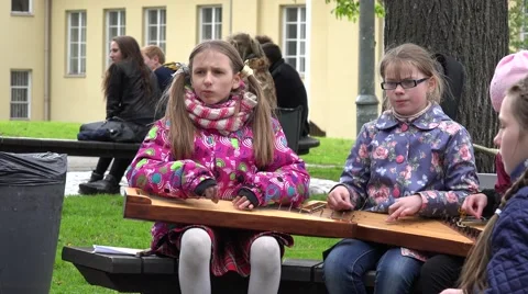 Girls with teacher play with string instruments. 4K Stock Footage 55546241