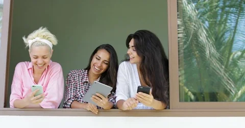 Girls Use Cell Smart Phones Talking Take Selfie Photo Standing At Window Sill Stock Footage