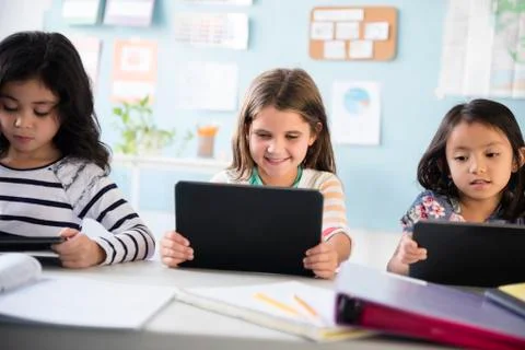 Girls using digital tablets in classroom 스톡 사진