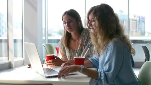 Girls Using laptop computer in coffee shop Видео 80267425