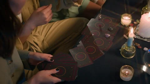 Girls Using Pendulum during Prediction Session with Tarot Cards Stock Footage 295218960