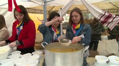 Girls-volunteers feed the homeless. Stock Footage