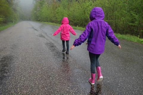 Girls walking in the rain Stock Photos