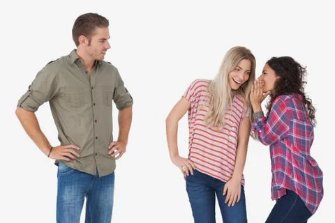 Girls whispering secrets and leaving man out Stock Photos