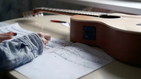 Girl'ss hands on table with pen learning music at home, make creation of notes Stock Footage 300260822