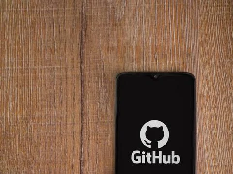 GitHub app launch screen with logo on the display of a black mobile smartphon Stock Photos