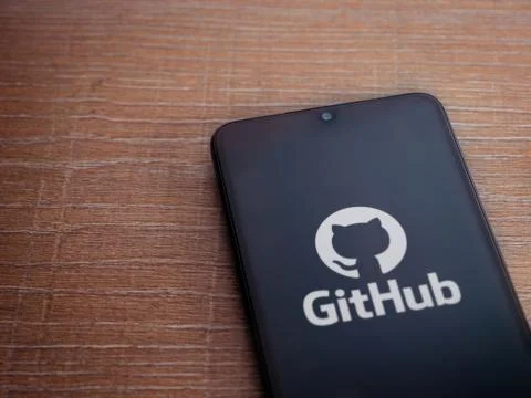 GitHub app launch screen with logo on the display of a black mobile smartphon Stock Photos