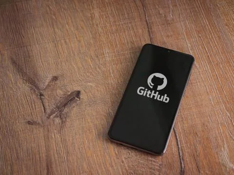 GitHub app launch screen with logo on the display of a black mobile smartphon Stock Photos