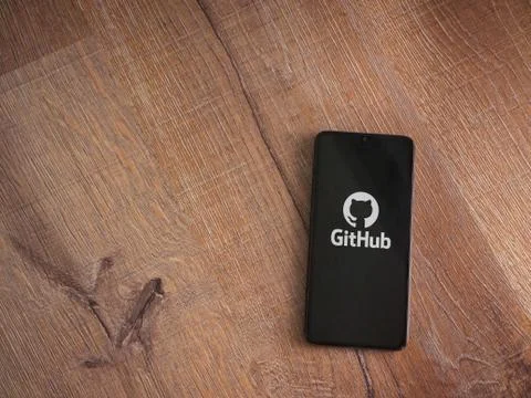 GitHub app launch screen with logo on the display of a black mobile smartphon Stock Photos
