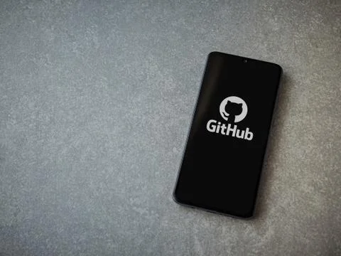 GitHub app launch screen with logo on the display of a black mobile smartphon Stock Photos