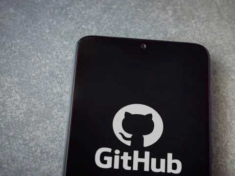 GitHub app launch screen with logo on the display of a black mobile smartphon Stock Photos