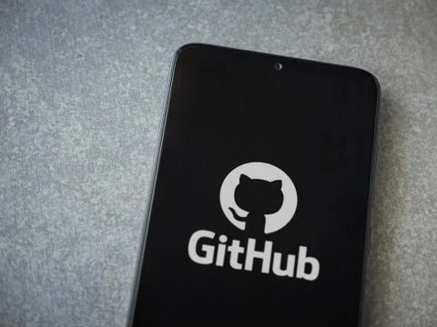 GitHub app launch screen with logo on the display of a black mobile smartphon Stock Photos