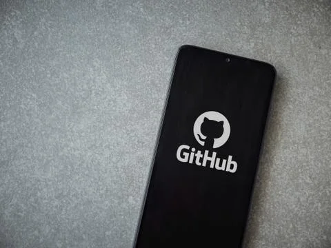 GitHub app launch screen with logo on the display of a black mobile smartphon Stock Photos