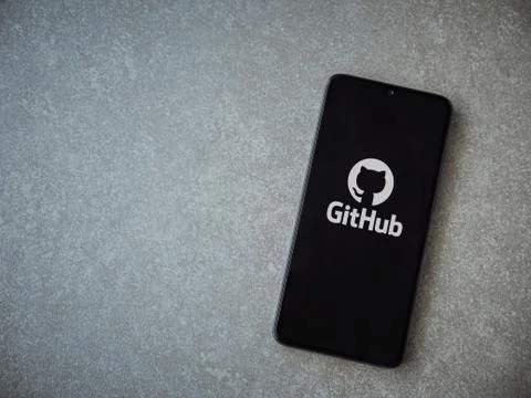 GitHub app launch screen with logo on the display of a black mobile smartphon Stock Photos