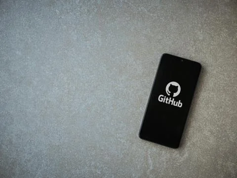 GitHub app launch screen with logo on the display of a black mobile smartphon Stock Photos