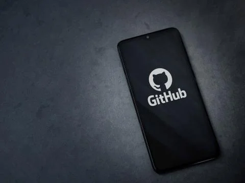 GitHub app launch screen with logo on the display of a black mobile smartphon Stock Photos