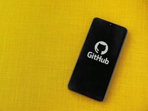 GitHub app launch screen with logo on the display of a black mobile smartphon Stock Photos