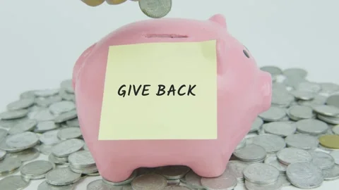 Give Back Word Or Text on Yellow Note Paper and Hand Inserting Coins Stock Footage 301508924