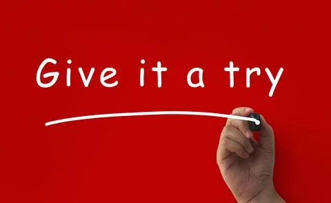 Give it a try, written on red cover background. Encouragement concept Stock Photos
