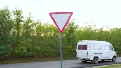 Give way yield road traffic sign and truck in the background Stock Footage 142010132