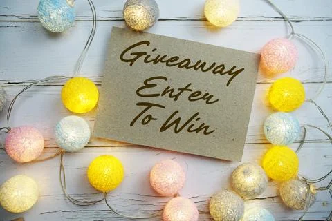 Giveaway Enter To Win text with gift present and LED cotton balls decorate .. Stock Photos
