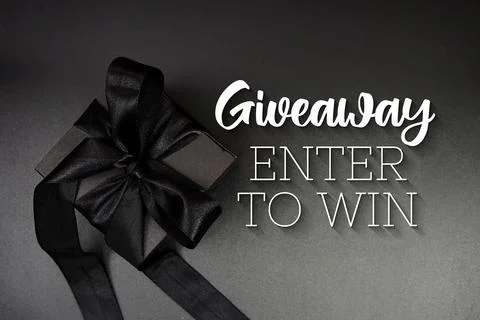 Giveaway Enter To Win text with gift box present and alarm clock on black b.. Stock Photos