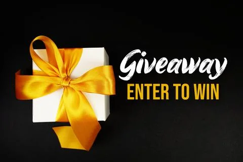 Giveaway Enter to Win text with gift box present on black background Stock Photos