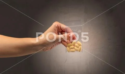 Giving drugs in plastic bag Stock Photos