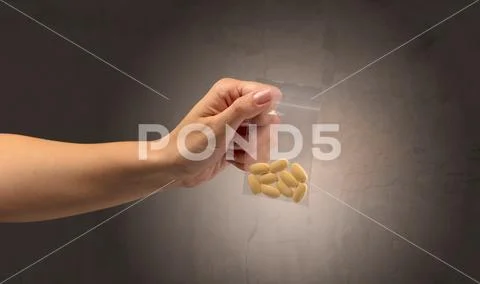 Giving drugs in plastic bag Stock Photos