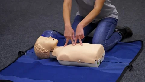 Giving first aid CPR on a dummy. Stock Footage 143590163