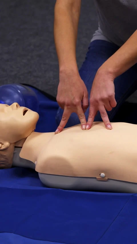 Giving first aid CPR on a dummy.  Stock Footage 272999989