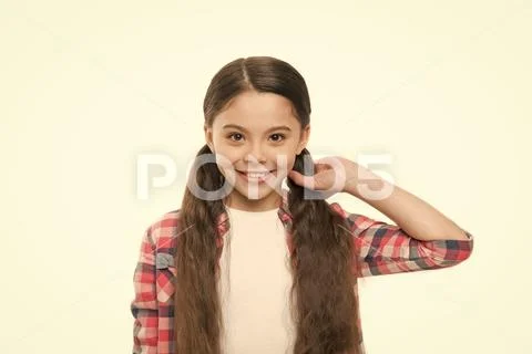 Giving hair a silky perfection. Pretty girl with long hairstyle. Little girl Stock Photos