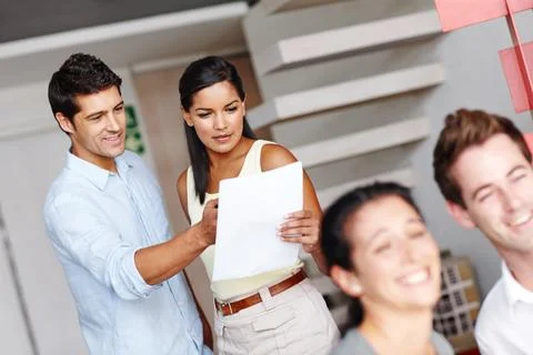 Giving her pointers. Two creative directors discussing a project brief while Stock Photos