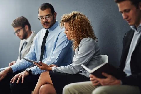 Giving him a few pointers before his interview. a group of businesspeople Stock Photos