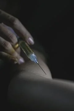 Giving an injection in arm Stock Photos