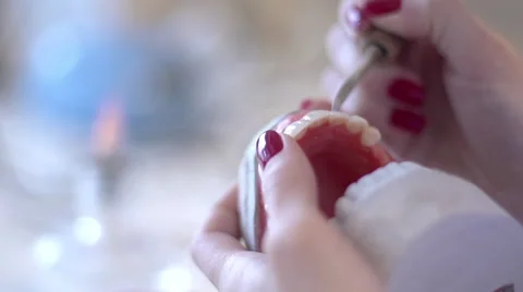 Giving Shape to Tooth in Laboratory for mount, false teeth Stock Footage 59807118