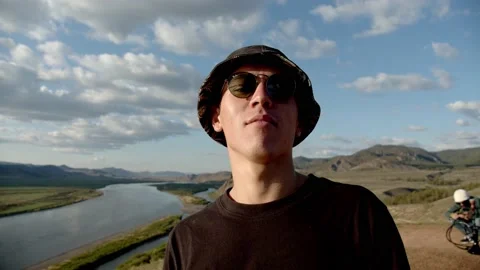 Gjuy in a hat dancing outside in the sunset Stock Footage 130781729