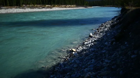 GLACIAL BLUE RIVER FLOWS BY Stock Footage 59072484