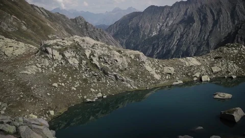 Glacial corrie in mountain range with mountain lake Stockbeeldmateriaal 87477905