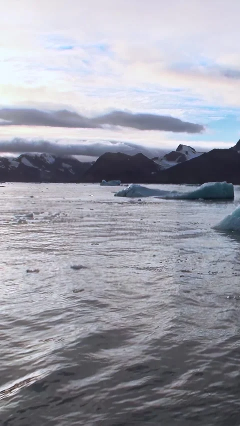 Glacial Giants Float Through a Serene Arctic Landscape Stock Footage 340485275