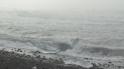Glacial Ice Chunk Resting in Ocean Surf at Diamond Beach in Iceland Stock Footage 339952923