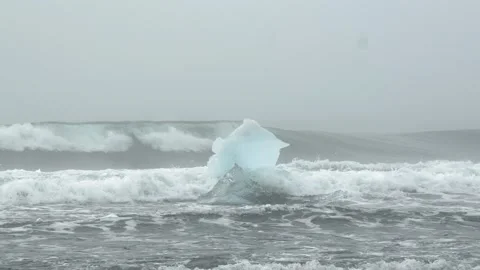 Glacial Ice Structure Drifting in Atlantic Waves at Diamond Beach in Iceland Stock Footage 339952708
